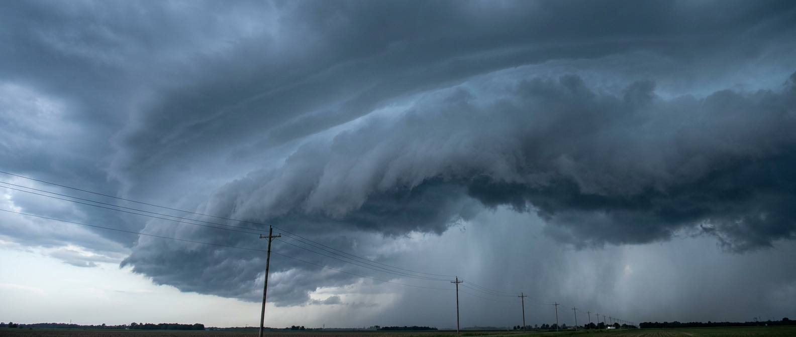 Dark shelf cloud approaching power lines